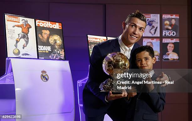 Cristiano Ronaldo of Real Madrid and his son Cristiano Ronaldo Jr. Pose with the Ballon D'Or 2016 trophy at Estadio Santiago Bernabeu on December 12,...