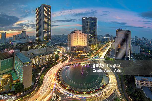the hotel indonesia roundabout sunset - jakarta - jakarta stock pictures, royalty-free photos & images