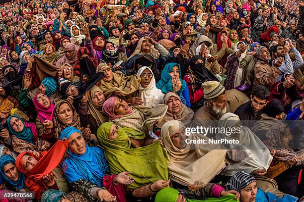 . Kashmiri Muslim women devotees look towards a cleric displaying the holy relic believed to be the whisker from the beard of the Prophet Mohammed,...