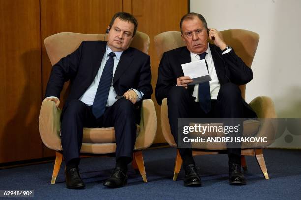 Russian Foreign Minister Sergey Lavrov talks to his Serbian counterpart Ivica Dacic as they sit in armchairs during a press conference after the BSEC...