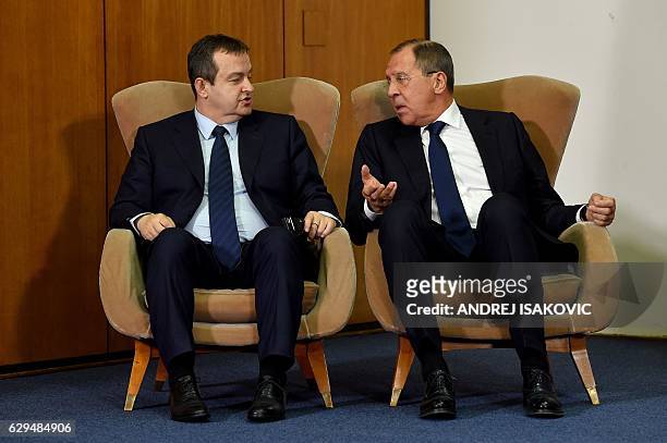 Russian Foreign Minister Sergey Lavrov talks to his Serbian counterpart Ivica Dacic as they sit in armchairs during a press conference after the BSEC...
