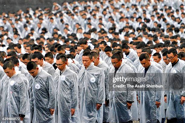 Attendees observe a minute of silence to commemorate the victims during the state memorial ceremony for the Nanjing Massacre at Nanjing Massacre...