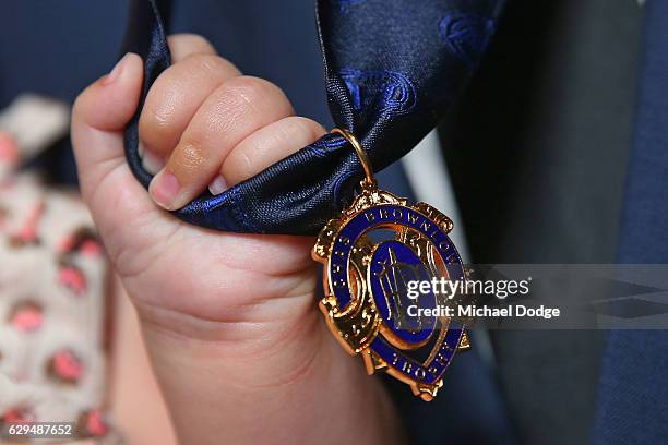 Trent Cotchin of the Richmond Tigers has daughter Mackenzie Foxx take a firm hold of his Brownlow Medal during the 2012 Brownlow Medal presentation...