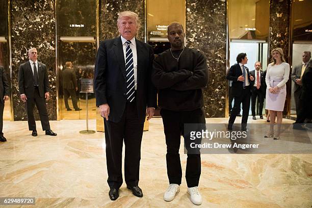 President-elect Donald Trump and Kanye West stand together in the lobby at Trump Tower, December 13, 2016 in New York City. President-elect Donald...