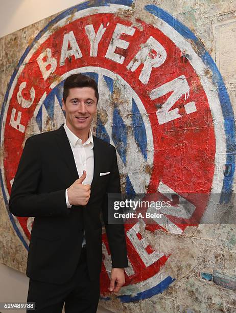 Robert Lewandowski of FC Bayern Muenchen gives a thumb up after he signed to extend his contract until 2021 on December 13, 2016 in Munich, Germany.