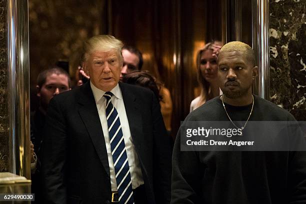 President-elect Donald Trump and Kanye West exit an elevator and walk into the lobby at Trump Tower, December 13, 2016 in New York City....
