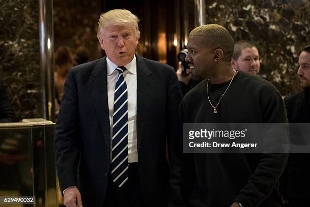 President-elect Donald Trump and Kanye West walk into the lobby at Trump Tower, December 13, 2016 in New York City. President-elect Donald Trump and...