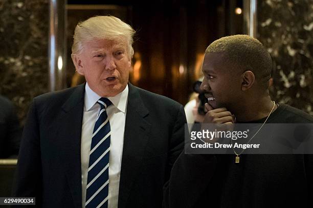 President-elect Donald Trump and Kanye West walk into the lobby at Trump Tower, December 13, 2016 in New York City. President-elect Donald Trump and...