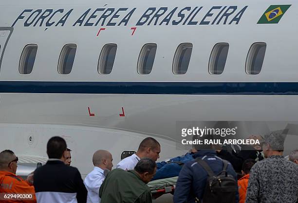 Members of the Brazilian Air Force carry Chapecoense player Alan Rushell on a plane departing to Brazil, in Rionegro, Antioquia department, Colombia...
