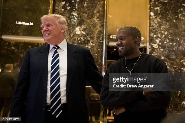 President-elect Donald Trump and Kanye West stand together in the lobby at Trump Tower, December 13, 2016 in New York City. President-elect Donald...