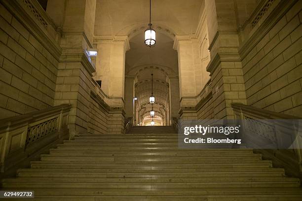 Stone stairway light by pendulum lights is seen at the Palais de Justice in Paris, France, on Tuesday, Dec. 13, 2016. Christine Lagarde, now the...