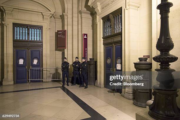 Police officers stand outside the courtroom holding the trial of Christine Lagarde, managing director of the International Monetary Fund at the...