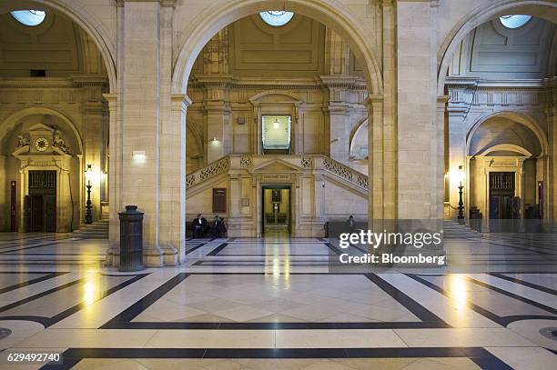 Lawmakers sit on seating inside the hallway of the Palais de Justice in Paris, France, on Tuesday, Dec. 13, 2016. Christine Lagarde, now the...