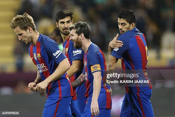 Barcelona's Luis Suarez , Linonal Messi , Ivan Rakitic and André Gomes celebrate after a goal during a friendly football match between FC Barcelona...