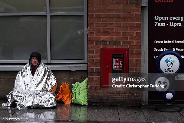 Homeless man, who gave his name as Dave, begs on the streets of Birmingham as austerity measures lead to the city council to cut services for...