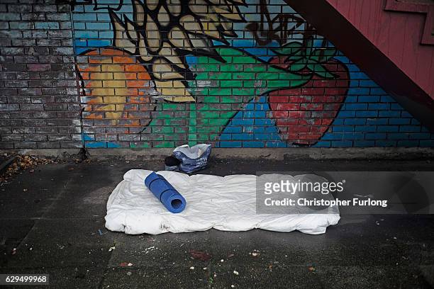 The bedding of a homeless person sits under a stairwell as austerity measures lead the city council to cut services for vulnerable people on December...