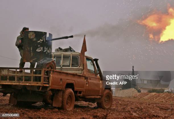 Syrian opposition fighters fire towards positions held by Islamic State group jihadists in al-Bab on the northeastern outskirts of the northern...