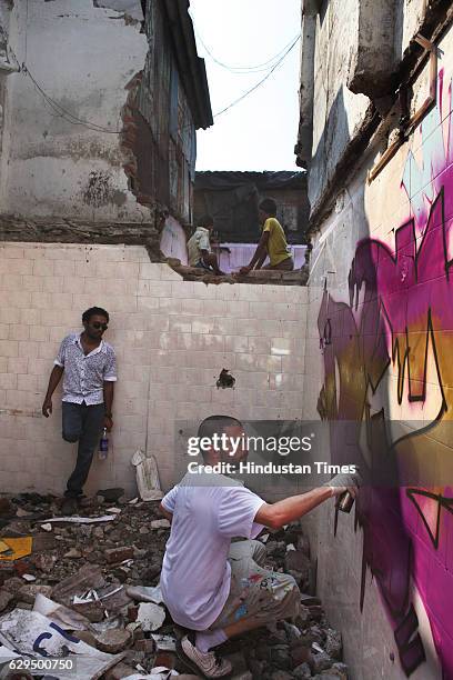 Graffiti artist Martin from France panted a wall at Mahim tulsi pipe road