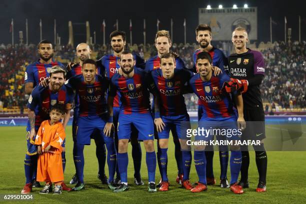 Afghan boy Murtaza Ahmadi poses for a picture with the FC Barcelona team: Rafinha, Javier Mascherano, André Gomes, Ivan Rakitic, Gerard Piqué, Ter...