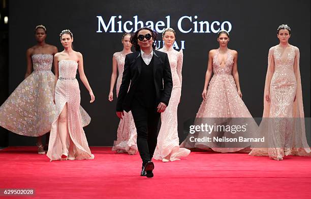 Fashion designer Michael Cinco with models walk the red carpet after his show during D3 Presents: DIFF Fashion Forward on day seven of the 13th...