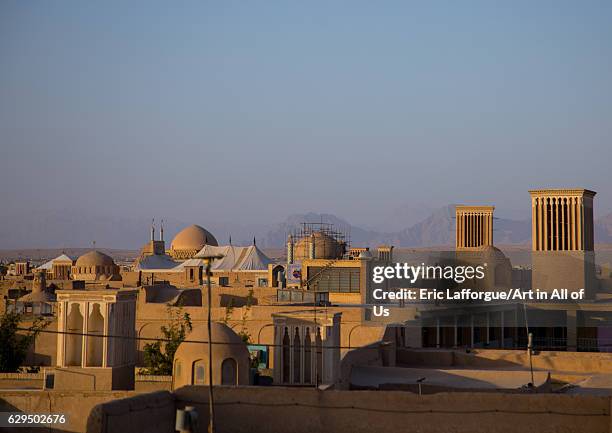 View of the city with traditional wind catchers and mosques at dusk, Yazd Province, Yazd, Iran on October 18, 2016 in Yazd, Iran.