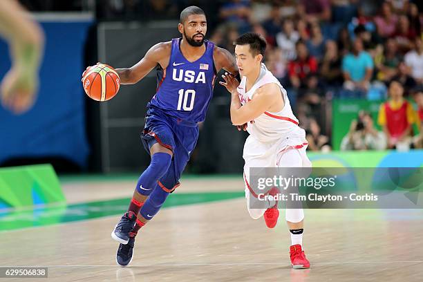 Basketball - Olympics: Day 1 Kyrie Irving of United States drives to the basket defended by Jiwei Zhao of China during the USA Vs China Men's...