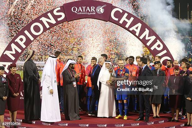 Qatar airways CEO Akbar Al Baker presenting the trophy to Andres Iniesta of Barcelona after winning the Qatar Airways Cup match between FC Barcelona...