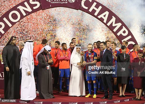 Qatar airways CEO Akbar Al Baker presenting the trophy to Andres Iniesta of Barcelona after winning the Qatar Airways Cup match between FC Barcelona...