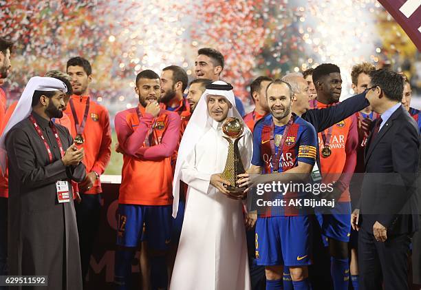 Qatar airways CEO Akbar Al Baker presenting the trophy to Andres Iniesta of Barcelona after winning the Qatar Airways Cup match between FC Barcelona...