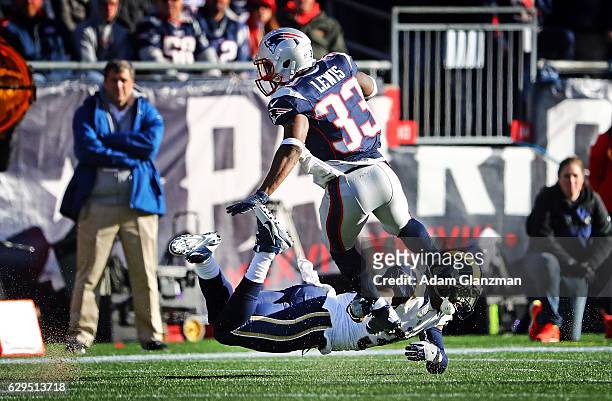 Dion Lewis of the New England Patriots is tackled by Maurice Alexander of the Los Angeles Rams during the first half of a game at Gillette Stadium on...
