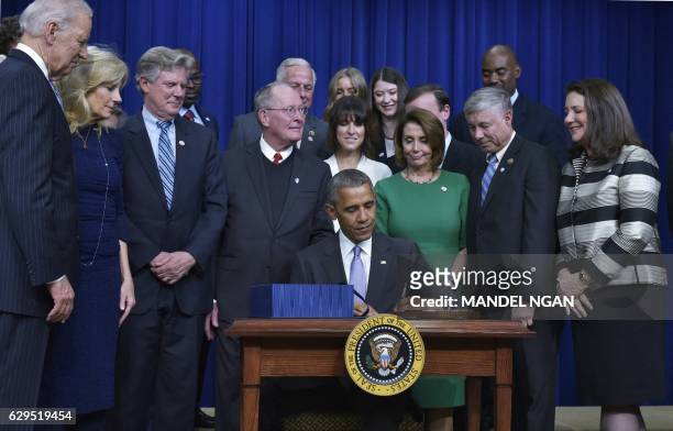 President Barack Obama signs the 21st Century Cures Act in the South Court Auditorium, next to the White House on December 13, 2016 in Washington,...