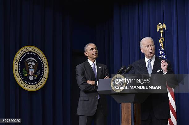 Vice President Joe Biden speaks, watched by US President Barack Obama, during the signing ceremony for the 21st Century Cures Act in the South Court...