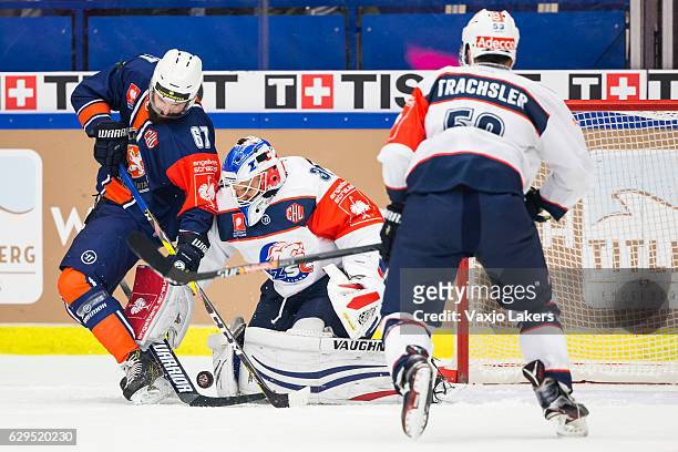 Linus Froberg of Vaxjo Lakers challenges Lukas Flueler Goaltender of ZSC Lions Zurich during the Champions Hockey League Quarter Final match between...