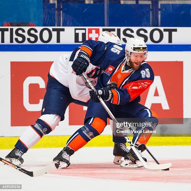 Liam Reddox of Vaxjo Lakers is checked from behind by Mattias Sjogren of ZSC Lions Zurich during the Champions Hockey League Quarter Final match...