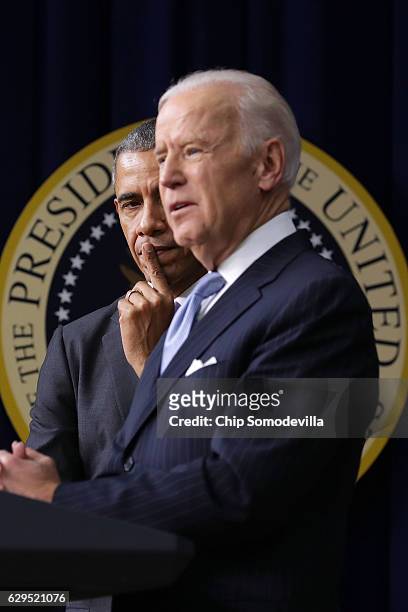 President Barack Obama listens to Vice President Joe Biden deliver remarks before signing the 21st Century Cures Act into law at the Eisenhower...
