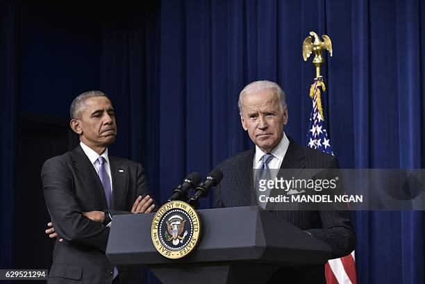 Vice President Joe Biden speaks, watched by US President Barack Obama, during the signing ceremony for the 21st Century Cures Act in the South Court...
