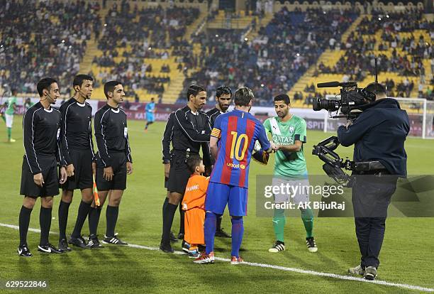 Afghan boy Murtaza Amadi with Lionel Messi of Barcelona during the Qatar Airways Cup match between FC Barcelona and Al-Ahli Saudi FC on December 13,...