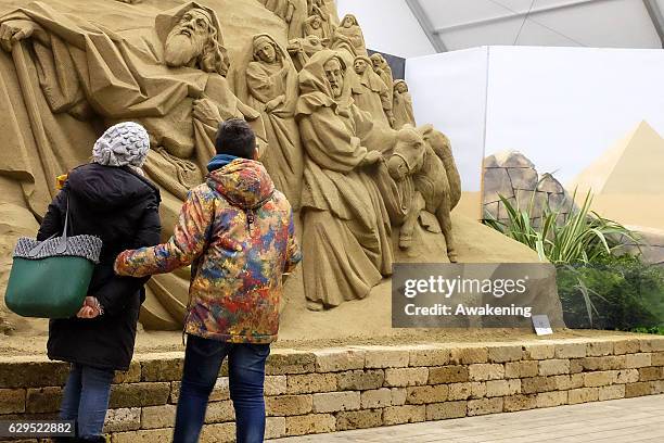 Peoples view one of the sculptures at the Jesolo Sand Nativity 2016 on December 13, 2016 in Jesolo, Italy.