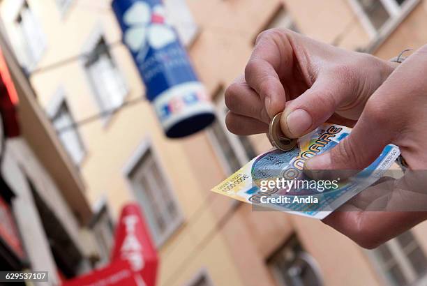 Scratch-card games of "La Francaise des jeux" , game of chance "Millionnaire" and sign of "La Francaise des jeux" . Game addiction, National lottery,...