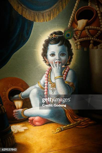 Painting in the London ISKCON hindu temple : Baby Krishna spilling butter