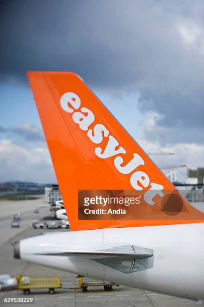 Low cost air transport , back aileron of an airline of the low cost airline company "Easyjet" on the tarmac of the airport in Lisbon in Portugal.