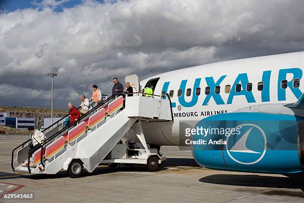 Tenerife Airport in the Canaries . Travelers on the gangway, leaving the Luxair plane.