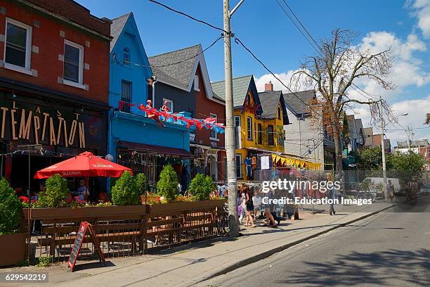 Colorful shops and buildings on Kensington Avenue Market in Toronto.