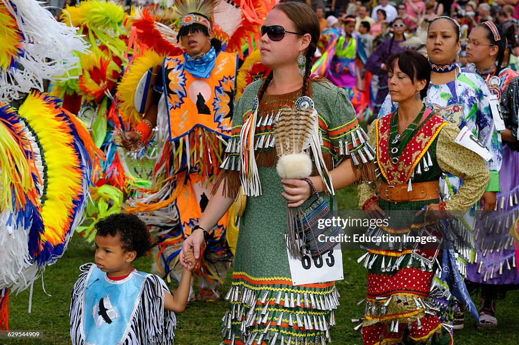 Native Indian male Fancy Dancers and women in jingle dresses at Six Nations Pow Wow
