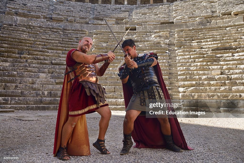 Roman Gladiators sword fighting on the stage at Aspendos theatre Turkey