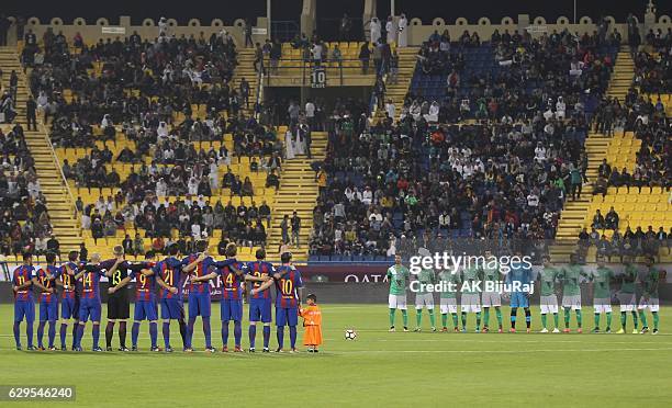 Teams observe one minute of silence during the Qatar Airways Cup match between FC Barcelona and Al-Ahli Saudi FC on December 13, 2016 in Doha, Qatar.