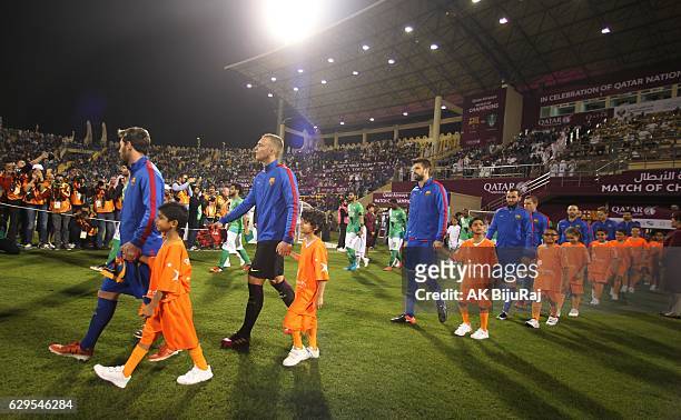 Teams line up during the Qatar Airways Cup match between FC Barcelona and Al-Ahli Saudi FC on December 13, 2016 in Doha, Qatar.