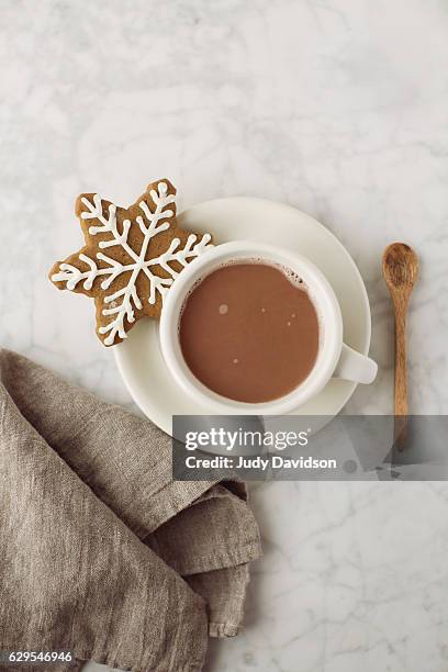 snowflake gingerbread cookie with hot chocolate - yule marble stock pictures, royalty-free photos & images