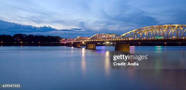 Gustave Eiffel's Bridge stretching across the Perfume River in Hu in Vietnam , the floodlit bridge at night. Tourism, South-Eastern Asia, Indo-China.