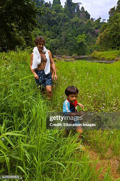 Father And Son At The I-Tu Waterfall On The Bolaven Plateau Near Pakse, Southern, Laos.